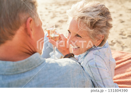 Champagne, senior beach couple laughing and love with mature care and support of marriage. Toast, wine and sea picnic of a old man and woman together on holiday in summer loving the sunshine outdoor 131804390
