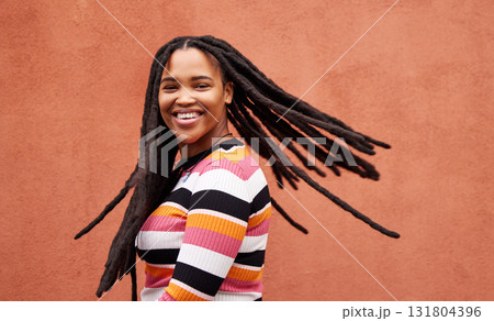 Playful, fun and portrait of a black woman with a smile isolated on a studio background. Happy, laughing and a funny young African girl with dreadlocks, happiness and expression on a backdrop Playful, fun and portrait of a black woman with a smile isolated on a studio background. Happy, laughing and a funny young African girl with dreadlocks, happiness and expression on a backdrop 131804396