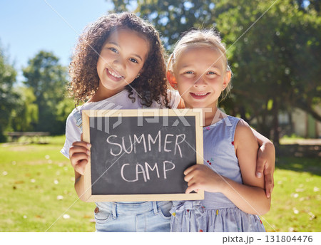 Summer camp, portrait or girls hugging in park together for fun bonding, development or playing in outdoors. Happy young best friends smiling or embracing on school holidays outside with board sign Summer camp, portrait or girls hugging in park together for fun bonding, development or playing in outdoors. Happy young best friends smiling or embracing on school holidays outside with board sign 131804476