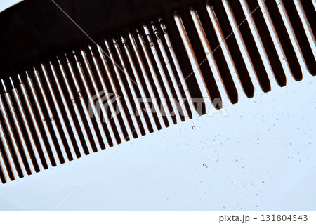A comb with hair serum. The photo shows the texture of the cosmetic product. A comb with hair serum. The photo shows the texture of the cosmetic product. 131804543