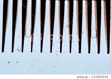 A comb with hair serum. The photo shows the texture of the cosmetic product. A comb with hair serum. The photo shows the texture of the cosmetic product. 131804545