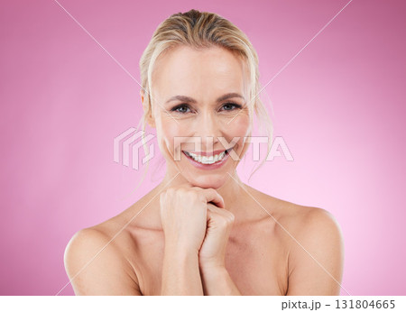 Beauty, skincare and portrait of mature, happy woman with smile and glowing skin, natural spa makeup in studio. Mockup, advertising and luxury cosmetics, face of model isolated on pink background. 131804665