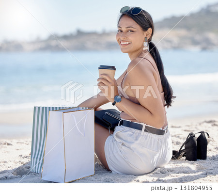 Woman with shopping bag, portrait and relax on beach after retail therapy, fashion and rest with coffee. Female outdoor, latte drink and smile, happy with discount or sale with freedom and travel Woman with shopping bag, portrait and relax on beach after retail therapy, fashion and rest with coffee. Female outdoor, latte drink and smile, happy with discount or sale with freedom and travel 131804955
