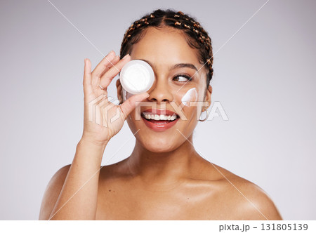 Skincare, health and woman with face cream in a studio for a beauty, natural and face routine. Cosmetic, wellness and female model with facial creme, spf or moisturizer treatment by a gray background 131805139
