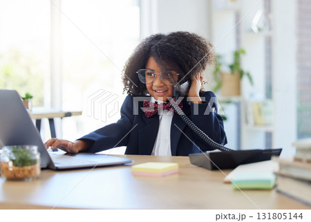 Young child, playing office and phone call with laptop for networking, contact or communication. Girl, smile and listening for deal, negotiation and reading website on computer at desk in workplace 131805144