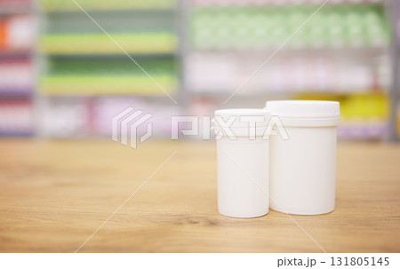 Pharmacy, medicine and mockup with a tablet containers for pills on a wooden countertop for treatment. Medical, insurance and healthcare in a drugstore with mock up for pharmaceutical advertising Pharmacy, medicine and mockup with a tablet containers for pills on a wooden countertop for treatment. Medical, insurance and healthcare in a drugstore with mock up for pharmaceutical advertising 131805145