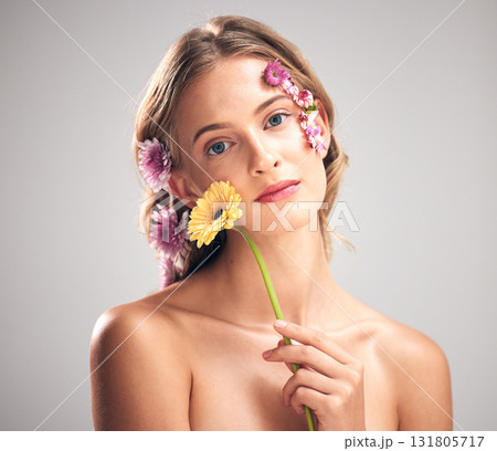 Skincare, flower and portrait of model in studio with beauty, natural and face routine. Floral, health and woman with organic, self care and fresh skin or facial treatment isolated by gray background 131805717