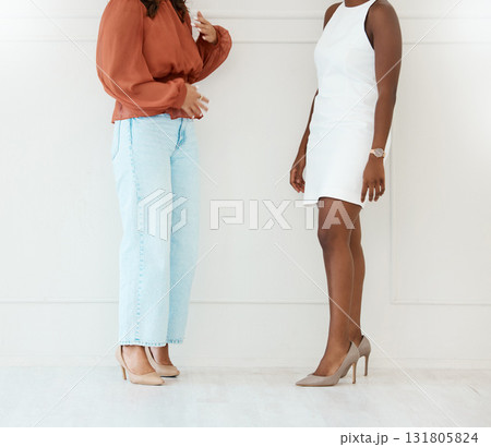 Fashion, shoes and business women by a wall in the office in conversation for teamwork. Discussion, planning and legs of professional corporate female employees with luxury outfits in the workplace. 131805824