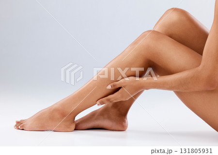 Cosmetics, skincare and legs with woman, dermatology and healthy lifestyle on grey studio background. Closeup, zoom and female with hair removal, salon treatment and luxury with pedicure and backdrop Cosmetics, skincare and legs with woman, dermatology and healthy lifestyle on grey studio background. Closeup, zoom and female with hair removal, salon treatment and luxury with pedicure and backdrop 131805931