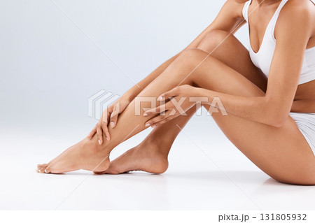 Woman, skincare and beauty legs for wellness, laser hair removal and studio background. Female model, leg and body cosmetics, shine and epilation for salon waxing, aesthetic pedicure and mockup glow 131805932