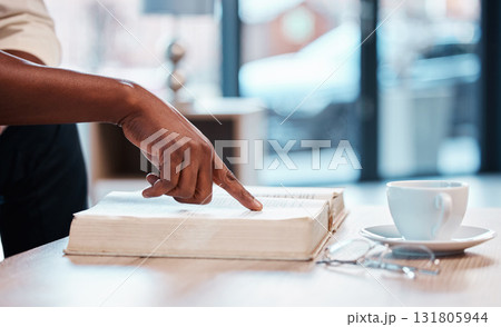 Hand, bible and a person reading in a cafe for religion, belief or faith in god and jesus. Education, learning and pointing with an adult in a coffee shop to study for spiritual knowledge in christ 131805944