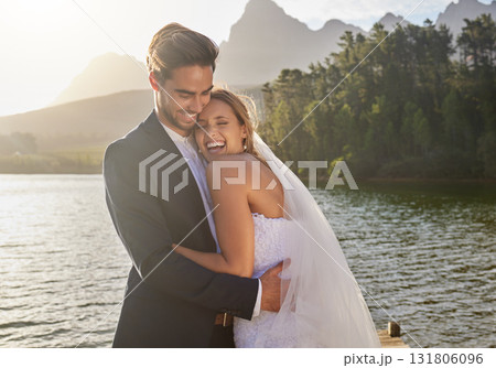 Happy, hug and couple at a lake wedding with love at a ceremony, celebration and marriage. Smile, affection and a man and woman hugging after romantic relationship commitment in nature together Happy, hug and couple at a lake wedding with love at a ceremony, celebration and marriage. Smile, affection and a man and woman hugging after romantic relationship commitment in nature together 131806096