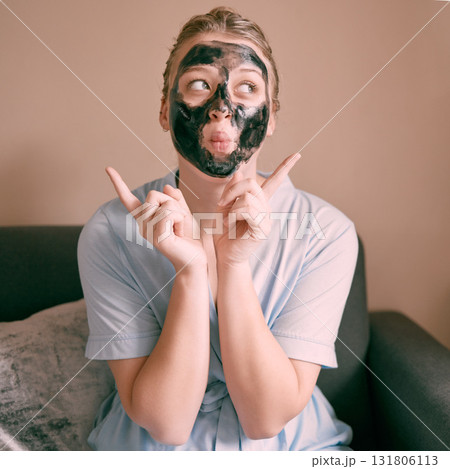 Skincare, face mask and goofy woman in her house, home or apartment doing morning beauty routine with hand gesture. Portrait, relax and funny female doing facial for self care using charcoal Skincare, face mask and goofy woman in her house, home or apartment doing morning beauty routine with hand gesture. Portrait, relax and funny female doing facial for self care using charcoal 131806113