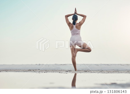 Rear view, balance pose and yoga by woman at the beach for wellness, zen and peace against ocean mockup. Back, standing and meditation by girl at the sea for energy, exercise and fitness workout Rear view, balance pose and yoga by woman at the beach for wellness, zen and peace against ocean mockup. Back, standing and meditation by girl at the sea for energy, exercise and fitness workout 131806143