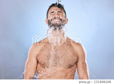 Man, water splash and skin care or shower with clean face for beauty, hygiene and dermatology. Aesthetic model person on blue background for health and wellness cosmetics, body and detox cleaning 131806206