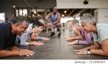 Senior people, fitness and plank with personal trainer in class for workout, core exercise or training at gym. Elderly group in coaching ab session for strong abdominal muscles on gymnasium floor 131806267