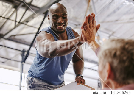 Fitness, gym and man high five for senior support, personal trainer goals and exercise progress. Workout, success and elderly person with black man for achievement and hands together sign in training 131806269