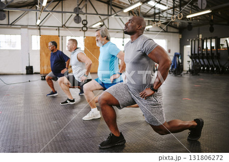 People, fitness and stretching legs in class with personal trainer at gym for workout, exercise or training. Diverse group in warm up leg lunge session with coach for cardio wellness on floor People, fitness and stretching legs in class with personal trainer at gym for workout, exercise or training. Diverse group in warm up leg lunge session with coach for cardio wellness on floor 131806272