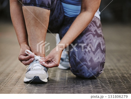 Hands, tie shoes and fitness in gym to start workout, training or exercise for wellness. Sports, athlete and woman tying sneakers or footwear laces to get ready for exercising or running for health. Hands, tie shoes and fitness in gym to start workout, training or exercise for wellness. Sports, athlete and woman tying sneakers or footwear laces to get ready for exercising or running for health. 131806279