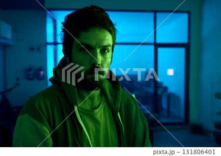 Man, portrait and criminal in dark neon garage with cybersecurity vision, software programming thinking or phishing. Hacker, face and night clothes for secret virus ideas of fraud scam or innovation Man, portrait and criminal in dark neon garage with cybersecurity vision, software programming thinking or phishing. Hacker, face and night clothes for secret virus ideas of fraud scam or innovation 131806401