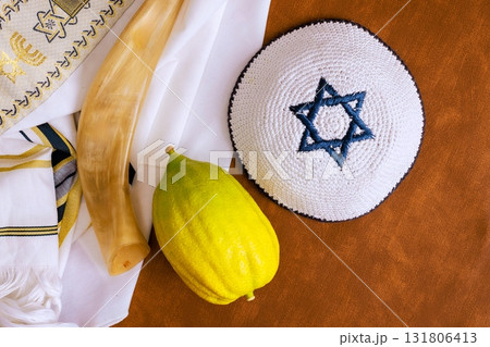 Traditional Jewish holiday etrog fruit with religious books. Sukkot celebration symbols 131806413