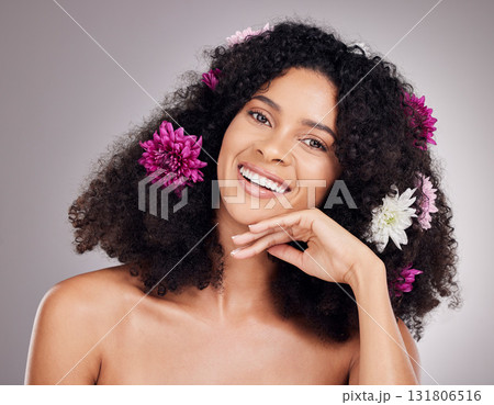 Face portrait, hair care flowers and black woman in studio isolated on gray background. Floral cosmetics, organic makeup and happy female model with flower for hairstyle, beauty skincare or wellness. Face portrait, hair care flowers and black woman in studio isolated on gray background. Floral cosmetics, organic makeup and happy female model with flower for hairstyle, beauty skincare or wellness. 131806516