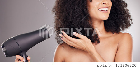 Hair care, beauty and black woman with hairdryer in studio isolated on gray background. Curly haircare, aesthetic or happy female model with machine to dry hairstyle after salon treatment for growth. 131806520