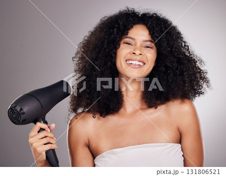 Beauty, portrait and black woman with hair dryer in studio isolated on gray background. Haircare, face and happy female model with machine to dry hairstyle after salon treatment for growth or texture 131806521