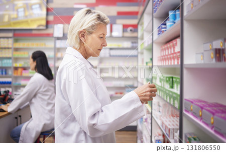 Pharmacy, doctor and medicine retail store with mockup stock on shelf for healthcare industry. Pharmacist woman reading info on pills, box or Pharma product for medical service, health and wellness 131806550