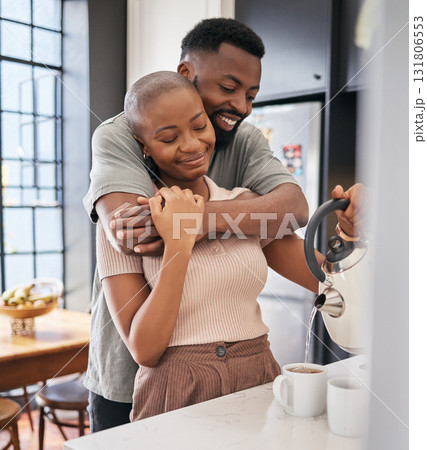 Morning, hug and African couple making coffee for energy, drink and routine in the kitchen. Smile, affection and black man and woman hugging while preparing tea, bonding and relaxing in their home Morning, hug and African couple making coffee for energy, drink and routine in the kitchen. Smile, affection and black man and woman hugging while preparing tea, bonding and relaxing in their home 131806553