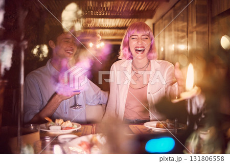 Happy couple at dinner, celebration at restaurant with fine dining, love and anniversary with young people laughing. Funny, happiness and eating, care in relationship with commitment and partnership 131806558