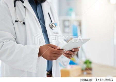 Black man, doctor and hands with tablet in healthcare research, planning or checking schedule appointment at hospital. Hand of African male medical expert working, browsing or search on touchscreen 131806603