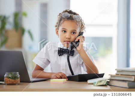 Kids, phone call and a girl playing in an office as a fantasy businesswoman at work on a laptop. Children, telephone and a female child working at a desk while using her imagination to pretend Kids, phone call and a girl playing in an office as a fantasy businesswoman at work on a laptop. Children, telephone and a female child working at a desk while using her imagination to pretend 131806645