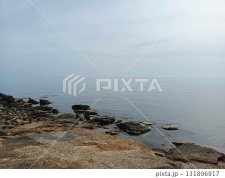 Rocky seashore with calm water 131806917