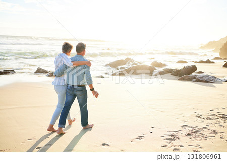 Beach, love and mockup with a senior couple walking on the sand by the ocean or sea for sunset romance. Nature, summer or back with a mature woman and man taking a romantic walk together on the coast 131806961