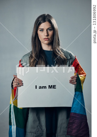 Woman, protest and poster in pride for gay, LGBTQ equality or human rights against gray studio background. Portrait of confident female activist with I am me message board for sexuality empowerment 131806992