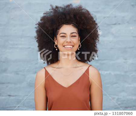 Portrait, happy woman and smile on brick wall background with happiness and joy. Face, confident and beauty of young, excited and mixed race person, girl or female from South Africa standing alone. 131807060
