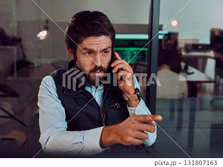 Programmer, phone call and man talking in office, chatting and speaking to contact at night. Information technology, pointing and thinking male employee or coder with mobile smartphone for networking Programmer, phone call and man talking in office, chatting and speaking to contact at night. Information technology, pointing and thinking male employee or coder with mobile smartphone for networking 131807163