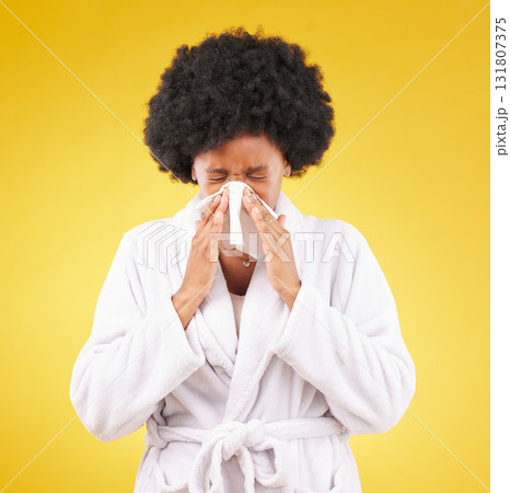 Black woman, afro and sick blowing nose with tissue and morning gown against a studio background. Isolated African American female with cold, flu or symptoms for illness, covid or fever on mockup Black woman, afro and sick blowing nose with tissue and morning gown against a studio background. Isolated African American female with cold, flu or symptoms for illness, covid or fever on mockup 131807375