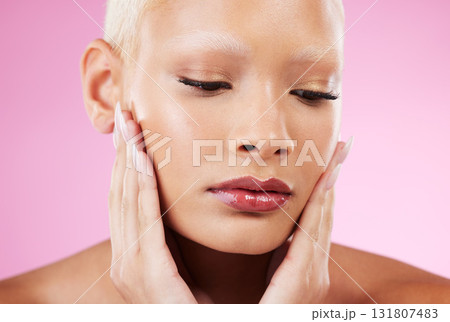 Woman, face and beauty skincare cosmetics in makeup or facial treatment against a pink studio background. Female hands touching soft, smooth or gentle skin in satisfaction for self love or care Woman, face and beauty skincare cosmetics in makeup or facial treatment against a pink studio background. Female hands touching soft, smooth or gentle skin in satisfaction for self love or care 131807483