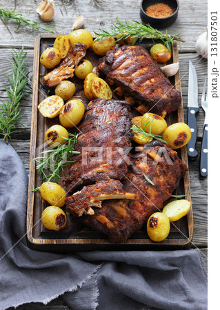 bbq baby pork ribs with potatoes, fresh rosemary bbq baby pork ribs with potatoes, fresh rosemary 131807501