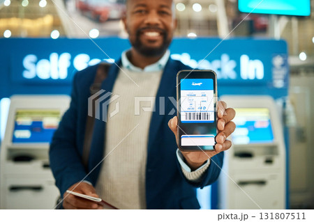 Airport, travel and man with a boarding pass on his phone to check in before his flight for a work trip. Technology, professional and African business male with a electronic plane ticket on cellphone Airport, travel and man with a boarding pass on his phone to check in before his flight for a work trip. Technology, professional and African business male with a electronic plane ticket on cellphone 131807511