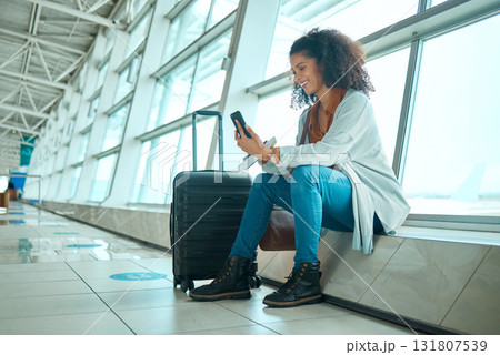 Travel, phone and black woman at airport on a video call waiting for plane travel and flight. Online, mobile connection and smile of a young female sitting at airplane terminal waiting for transport Travel, phone and black woman at airport on a video call waiting for plane travel and flight. Online, mobile connection and smile of a young female sitting at airplane terminal waiting for transport 131807539