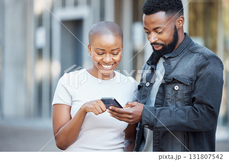 City, happy and couple browsing on a phone with social media, mobile app or the internet. Technology, 5g network and young African man and woman scrolling on a website with a cellphone in town. City, happy and couple browsing on a phone with social media, mobile app or the internet. Technology, 5g network and young African man and woman scrolling on a website with a cellphone in town. 131807542