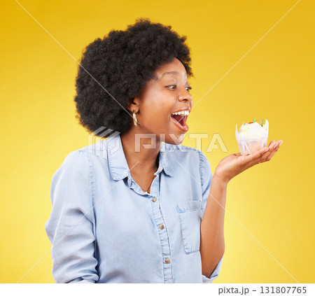 Black woman, cupcake and excited or happy in studio while eating sweet food on a yellow background. African female model with snack, dessert or cake for happiness, birthday or celebration mockup Black woman, cupcake and excited or happy in studio while eating sweet food on a yellow background. African female model with snack, dessert or cake for happiness, birthday or celebration mockup 131807765