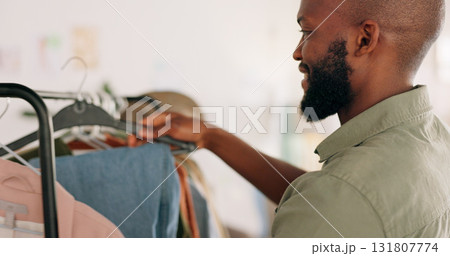 Man designer, entrepreneur startup and clothes shopping rack in boutique and design studio. Happy worker, creative job and wardrobe of clothing, fashion and professional working in retail store 131807774