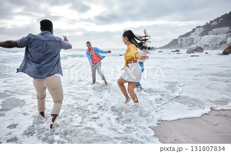 Friends at beach, water splash and ocean with travel and adventure, group of people have fun on holiday. Diversity, playful and nature, social get together and laugh, freedom outdoor in Los Angeles Friends at beach, water splash and ocean with travel and adventure, group of people have fun on holiday. Diversity, playful and nature, social get together and laugh, freedom outdoor in Los Angeles 131807834