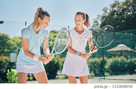 Tennis, sport and women with athlete and coach on outdoor turf, training instructor with fitness motivation and help. Exercise, sports lesson and workout together, teaching and learn skill on court Tennis, sport and women with athlete and coach on outdoor turf, training instructor with fitness motivation and help. Exercise, sports lesson and workout together, teaching and learn skill on court 131808050