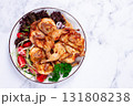 Baked quail, served on a plate with crispy lettuce leaves, fresh tomatoes and herbs, on a white plate, homemade, 131808238
