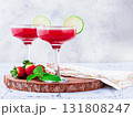 Refreshing cocktail in an elegant glass with lime and strawberries, sunshine, no people, 131808247